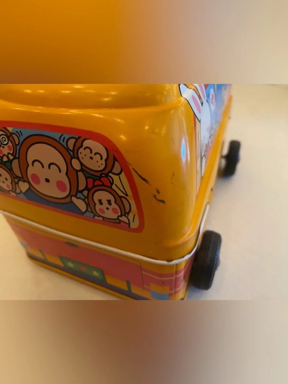 A Sanrio Yellow Toy Bus Metal Carry Case with Teal Handle